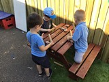 Childcare at table with rolling pins