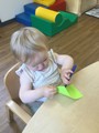 Child  sitting at table with paper and pen