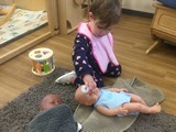 child playing with dolls