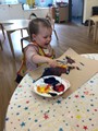 child at table painting