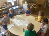 Children at table with cards and numbers